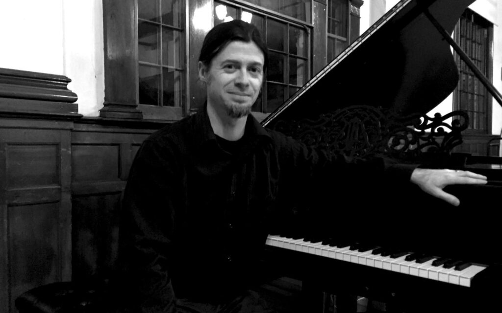 Trevor Berens sitting at a piano.